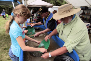 Gold panning with children and rock club members.