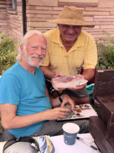 Vendor Thom Lane displays rare and unique rocks and minerals with collector friend.