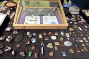 Polished rocks and minerals on display in vendor booth.