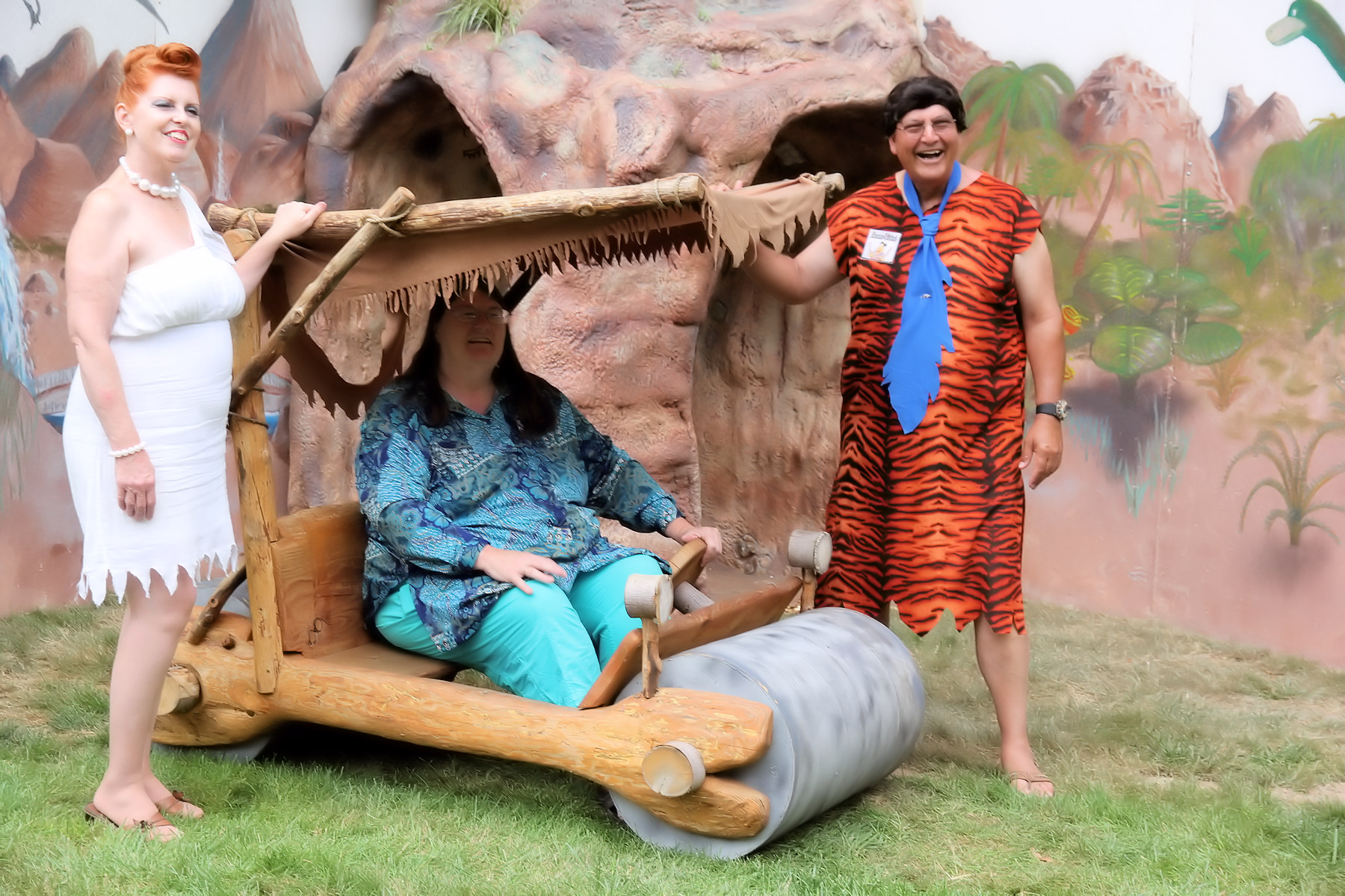 Fred and Wilma Flintstone and Summer Fest guest in Flintmobile.