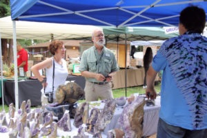 Julian Gray and Barb Epstein visit a vendor booth.