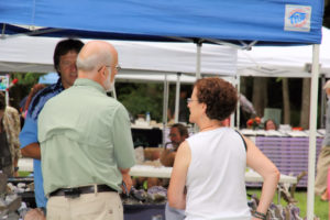 Julian Gray and Barb Epstein visit a vendor booth and shop.