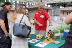 OMSI volunteer offers educational information on fossils.