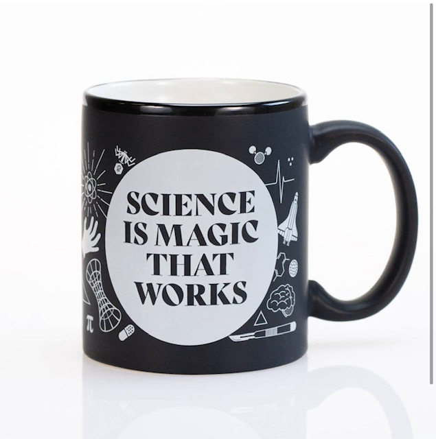 Black mug with white writing, "Science is Magic that Works."