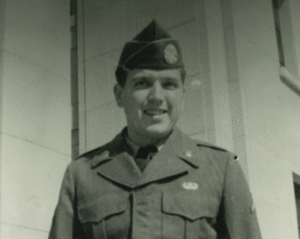 A man dressed in an American military uniform smiling at the camera.