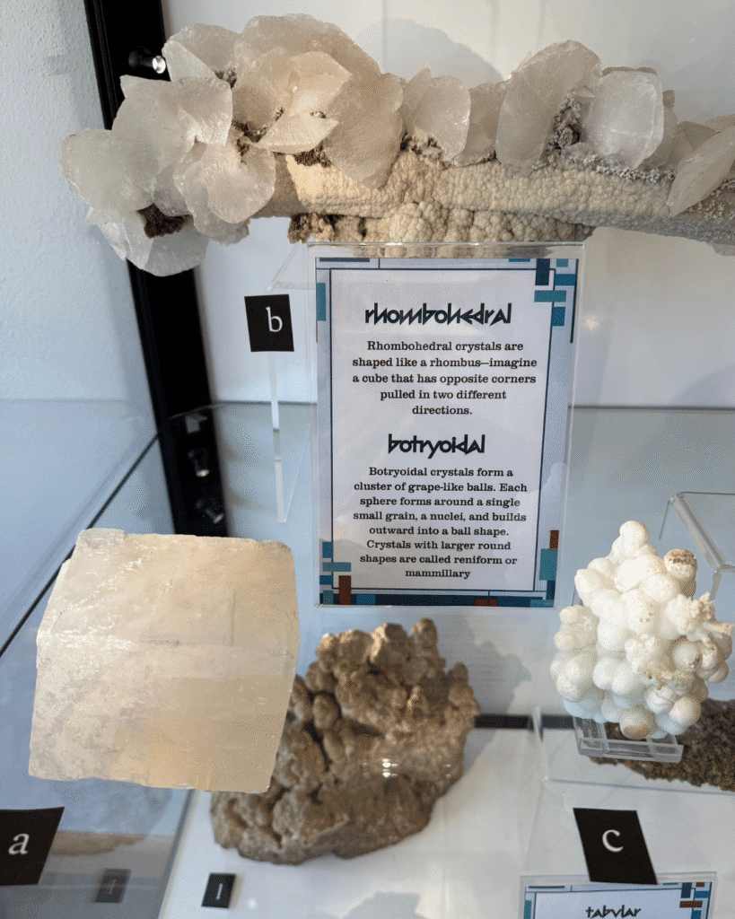 A close-up of three white calcite specimens. The one labelled A is rhombohedral, as is the one labelled B. The one labelled C is botryoidal.